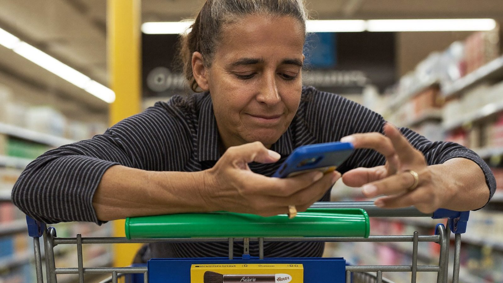 Shopper checking phone for PFAS in waterproof mascara before buying