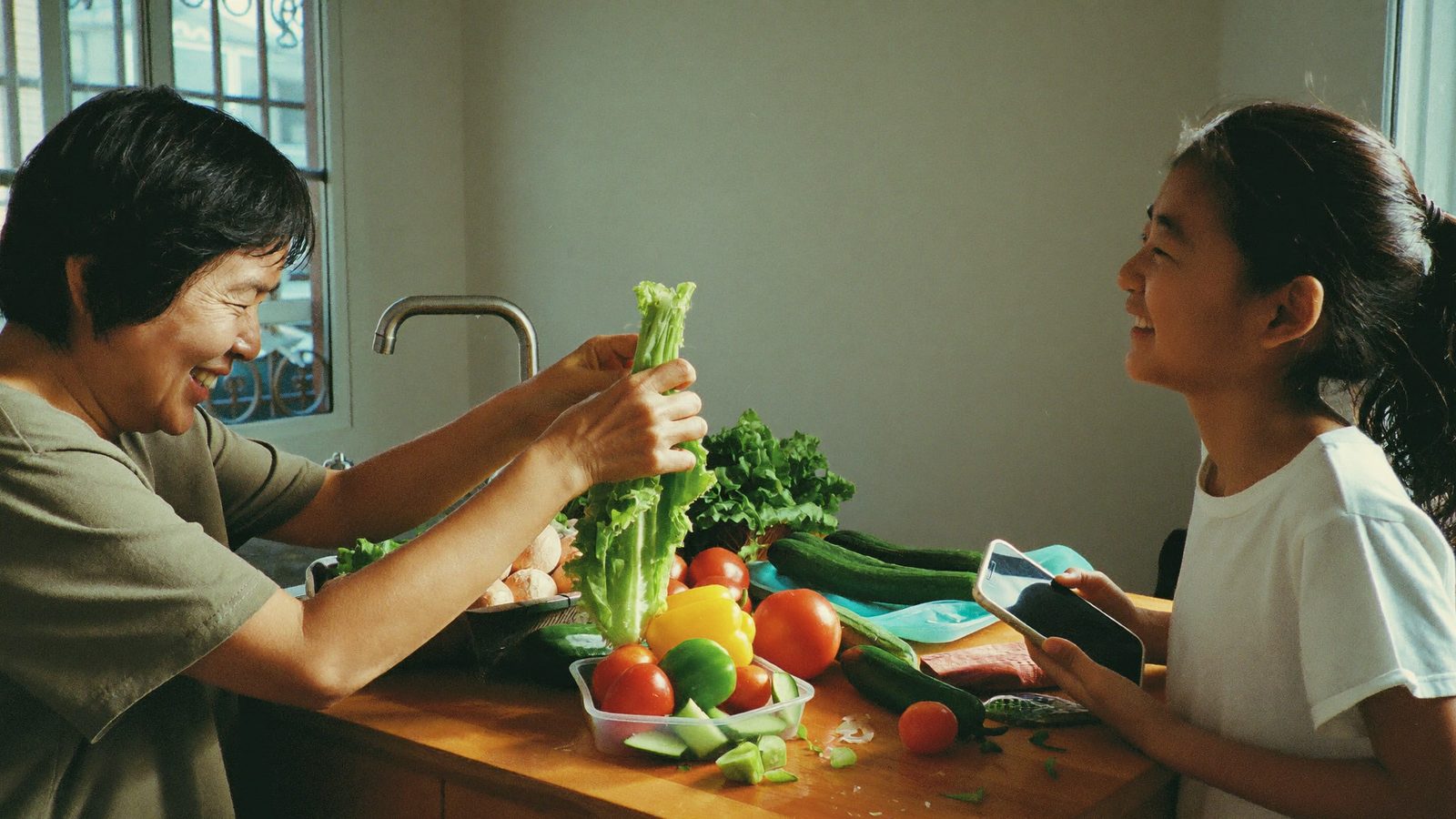 Mother and daughter choosing fresh food after checking scores in a health scanner app
